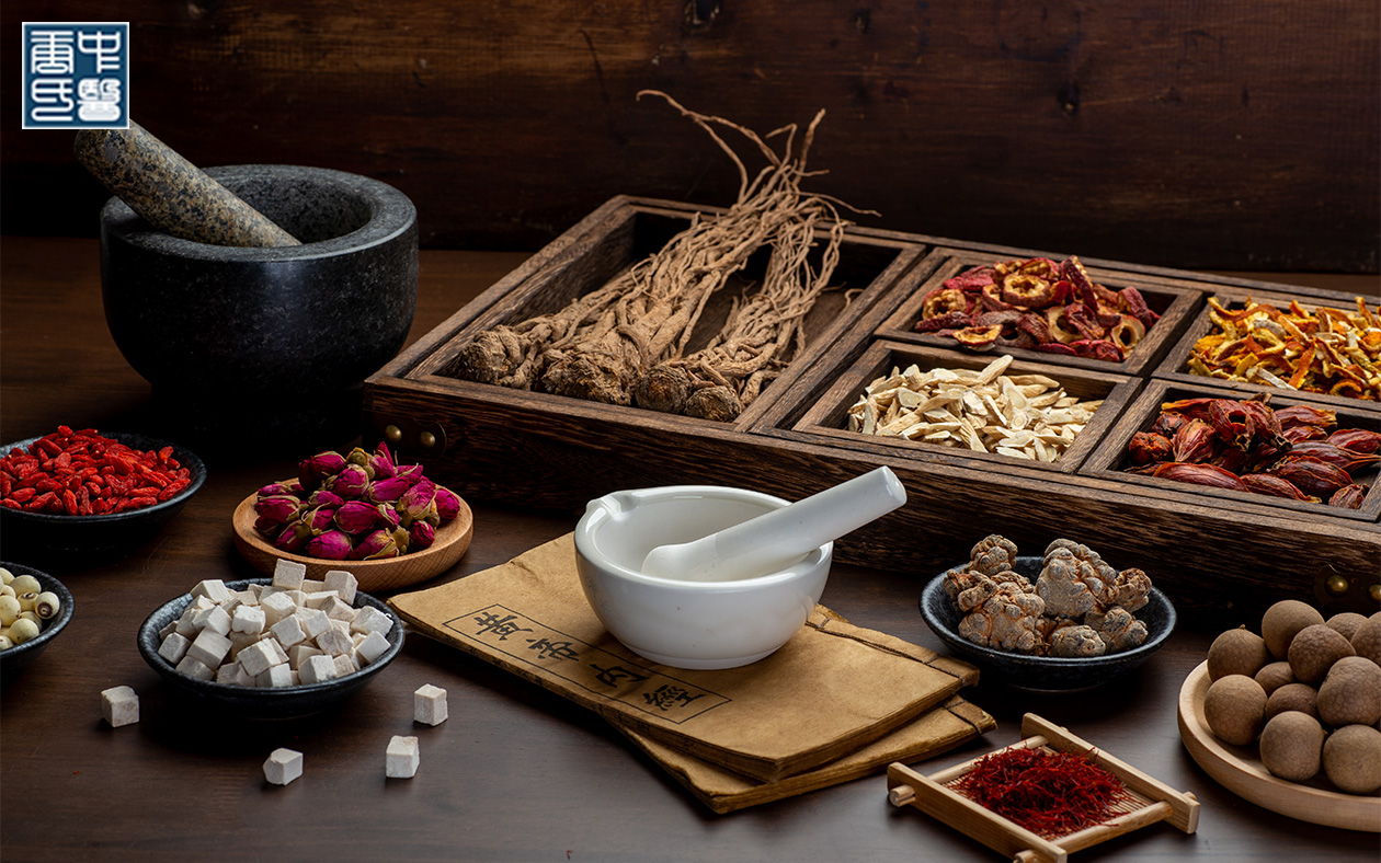 Assortment of dried TCM herbs in a wooden chest with mortar.